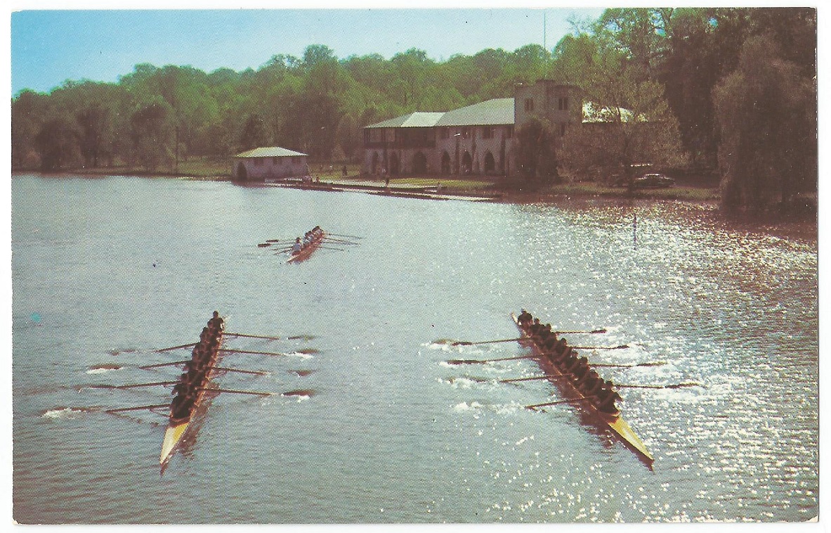 PC USA Princeton University crews on the waters of Carnegie Lake with boathouse in background